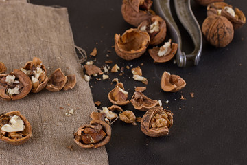 walnuts and nutcracker on table covered with burlap