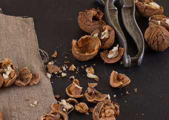 walnuts and nutcracker on table covered with burlap