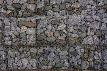Stone walls in net  prevent soil and stone slides at Kung Wiman, Chanthaburi, Thailand. background.