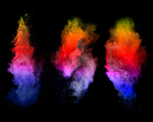 Obraz na płótnie Canvas Explosion of colored powders on black background