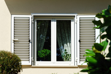 Window with shutters closeup view, sunny day on sea resort