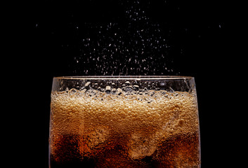 Ice cola with splashing CO bubbles. - obrazy, fototapety, plakaty