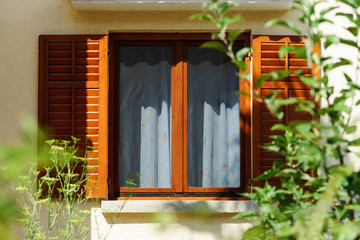 Window with shutters closeup view, sunny day on sea resort