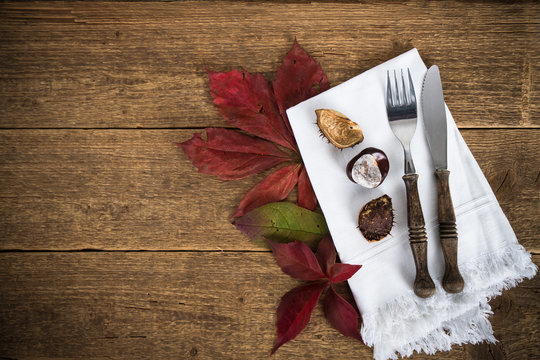 
fork and knife on napkin and chestnut