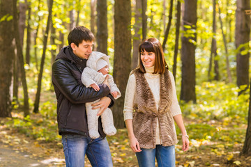 Fototapeta premium love, parenthood, family, season and people concept - smiling couple with newborn baby in autumn park
