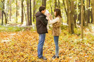 Fototapeta premium love, parenthood, family, season and people concept - smiling couple with newborn baby in autumn park