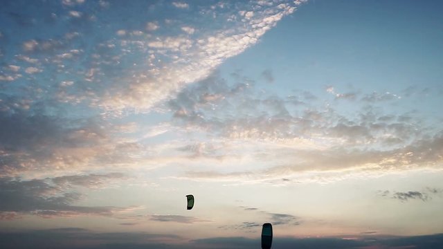 Three kites for kitesurfing flying at background of a sky with setting sun. HD