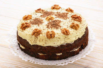 Carrot cake with cheese cream on white table.