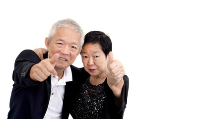 Asian senior couple in business attire showing hand gesture thum
