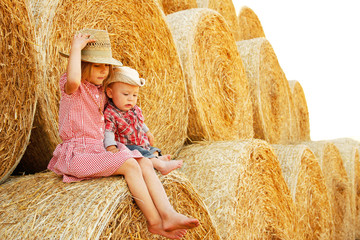 happy child on a field with bales harvest in autumn