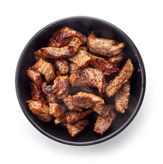 Bowl of grilled beef chunks isolated on white, from above