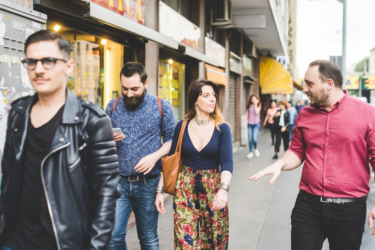 Group of friends walking on sidewalk
