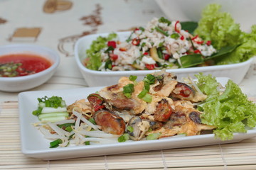 Fried oyster with bean sprouts with chili sauce.Selective focus.