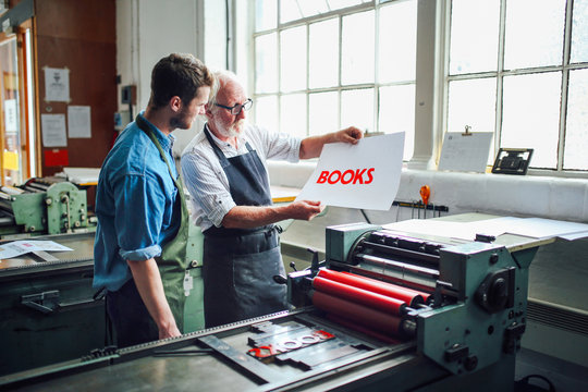 Men working with print in printing shop