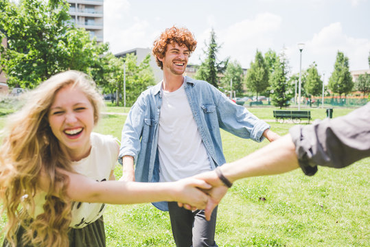 Friends circle dancing in park