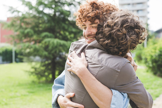 Friends hugging in park