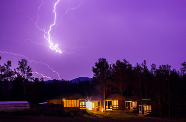 Lightning in the night sky over houses