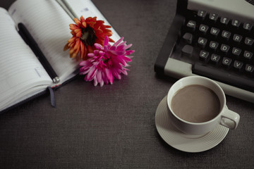 Vintage typewriter and coffee on stone board