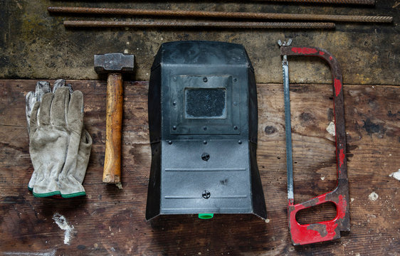 Gloves, hammer, welding visor, saw