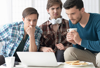 men watching video on laptop