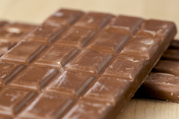 Chocolate bars on wooden floor