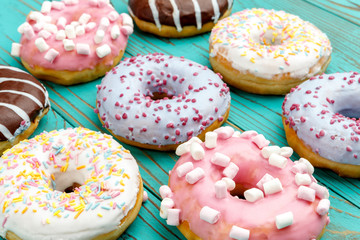 Donuts on colorful wooden background