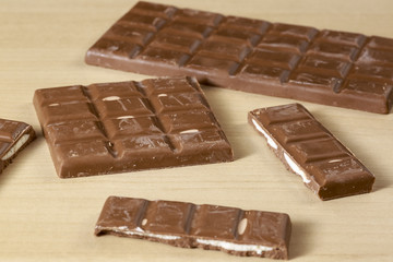 Filled chocolate bars on clear wood table