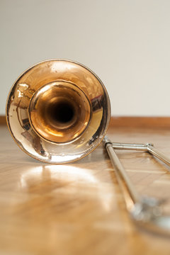 Trombone on wooden floor detail