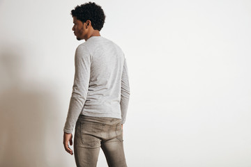 Back view of attractive latino man looking on side, isolated on white, wearing blank heather grey clothing