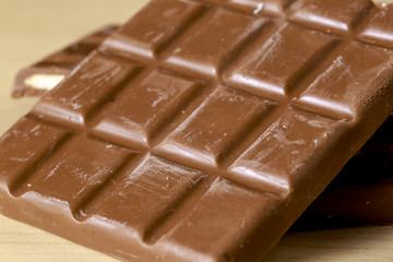 Chocolate bars with fruit taste fillings on wooden floor
