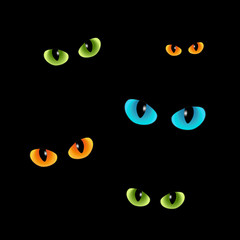 Green and blue, orange cats eyes on a black background