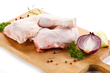 Raw chicken legs on cutting board 