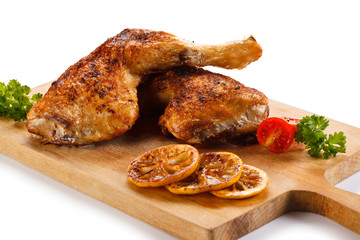 Roast chicken legs on cutting board 