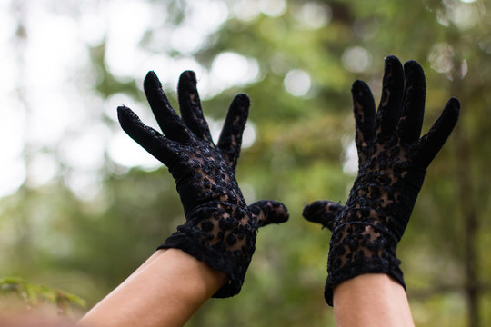 Hands in black gloves