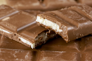 Bitten chocolate bars with fruit taste filling. Food background
