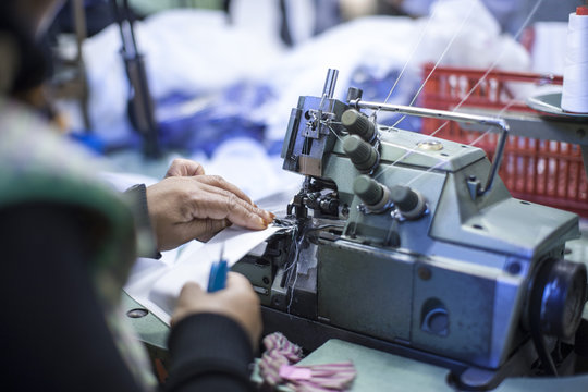 Seamstress In Clothing Factory Sewing Clothes