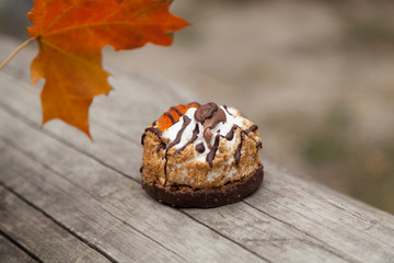 sweet cake and autumn yellow maple leaf