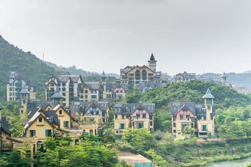Fototapeta na wymiar Luxury European village at the bottom of mountain at summer time in the Oversea Chinese Town (OCT east ) of Shenzhen, China