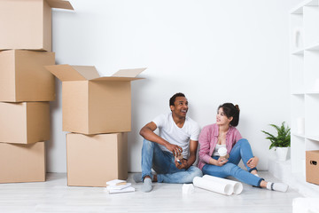 Young couple in a new house planning decoration moving home.