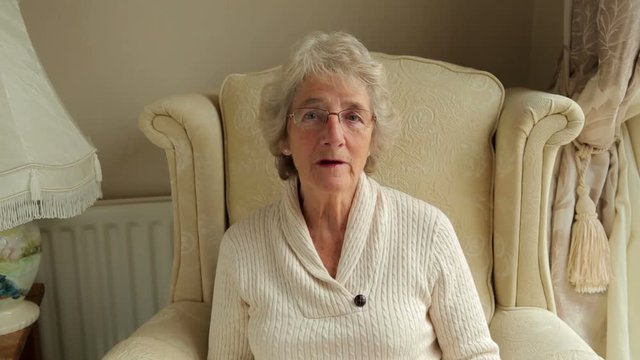 Senior woman speaks to camera for video chat or video call