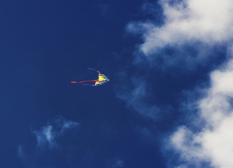 Fototapeta na wymiar Colorful kite flying in the blue sky
