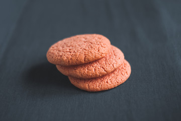 Chocolate, pink, round and delicious cookies on a gray background. Table. 