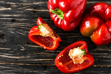 Red bell pepper on wooden background. Harvest