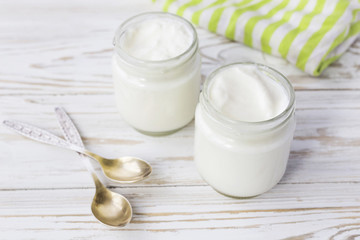 Obraz na płótnie Canvas Homemade yogurt in glass jar on wooden table.