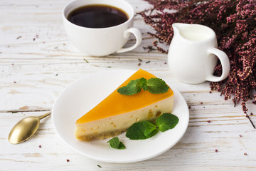 Cheesecake,  coffee, milk jar and heather flowers