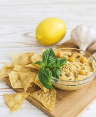 Fresh homemade organic hummus with pita cheaps and basil