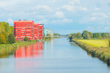 Fototapeta premium Shore of a canal in sunlight at fall