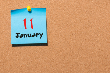 January 11th. Day 11 of month, Calendar on cork notice board. Winter time. Empty space for text