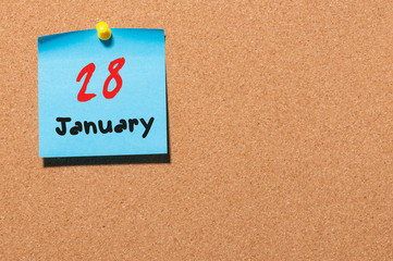January 28th. Day 28 of month, Calendar on cork notice board. New year at work concept. Empty space for text