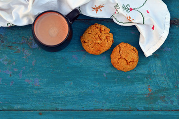 Cup of hot cocoa or chocolate with homemade oat cookies, top view
